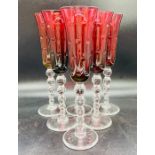 A set of six cranberry champagne flutes with bubble stems