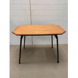 A Mid Century table on metal legs, red base and a teak top (H70cm W93cm D56cm)
