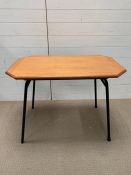 A Mid Century table on metal legs, red base and a teak top (H70cm W93cm D56cm)