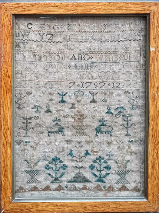 An 18th century Sampler worked in silk on linen ground, in a variety of stitches. Alphabets A-Z in