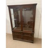 A reproduction display cabinet with lead glass and three glass shelves (H160cm W108cm D38cm)