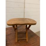 A small wooden folder up stool (H24cm W32cm D21cm)