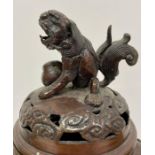 A Chinese urn or censor with Foo dog finial.