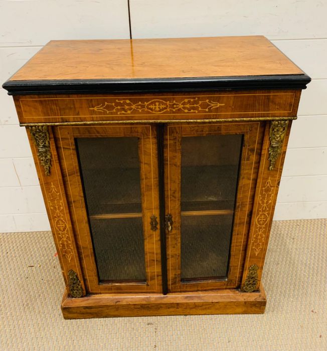 A Mahogany side cabinet with glazed doors to a single shelf, with string inlay and gilt. (60cm x - Image 2 of 3