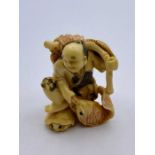 A signed ivory netsuke with Fisherman theme.