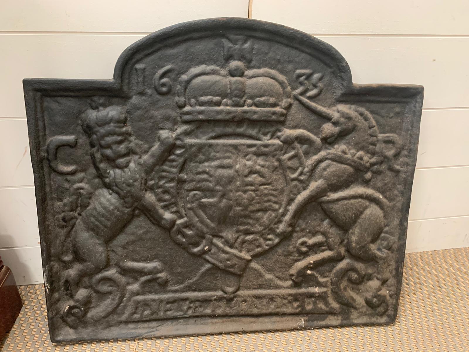 A Cast iron fire back, crested with a coat of arms 53cm x 60 cm
