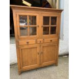 A glazed cabinet with doors opening to reveal shelves, three drawers and cupboard below (H171cm