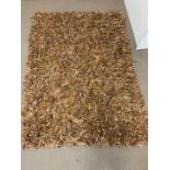 A leather and suede shaggy brown rug (220cm x 160cm)