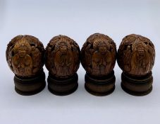 A Box of Four Antique Chinese carved walnuts on stands