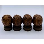 A Box of Four Antique Chinese carved walnuts on stands