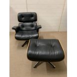A rosewood lounge chair and ottoman. After Charles and Roy Eames for Herman Milner with black
