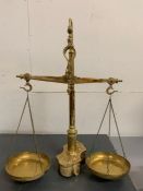 A Macro Braga brass scale with dolphin hooks and weights to base (H56cm W45cm)