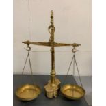 A Macro Braga brass scale with dolphin hooks and weights to base (H56cm W45cm)