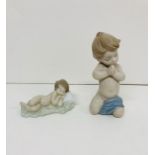 Two Lladro china babies, one praying and one sleeping