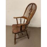 A 19th century yew and elm Windsor chair, the high double back with shaped and pierced splats turned