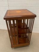 A Mahogany revolving bookcase with inlay flower crest to top 46 cm sq x 86 cm h