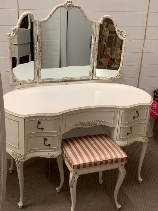 A dressing table with stool and matching floor standing mirror