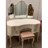 A dressing table with stool and matching floor standing mirror