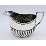 A silver milk jug by Harrison Brothers & Howson (George Howson), hallmarked for Sheffield 1902 (