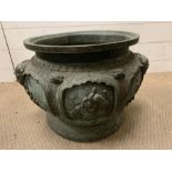 A Cast bronze Chinese planter with elephant handles, decorative panels featuring lotus leaves and