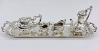 A silver miniature tea set by A Chick & Sons Ltd, hallmarked for London 1975