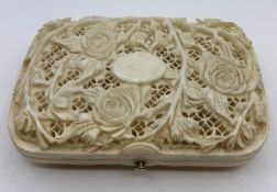 An Antique carved ivory cigarette case with rose theme