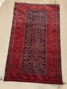 A red grounds rug or wall hanging with centre panel of geometric design (190cm x 115cm)