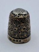 A silver thimble by H Fowler in leather box, hallmarked Birmingham 1900.