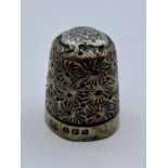 A silver thimble by H Fowler in leather box, hallmarked Birmingham 1900.