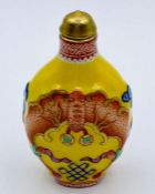 A Chinese scent bottle on yellow grounds.