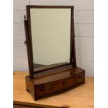 A mahogany toilet mirror sat on three drawers