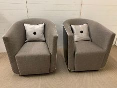 A pair of contemporary tub chairs with faux leather outer and fabric seat (H83cm W77cm D85cm)