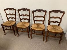 A set of four French oak rush seat dining chairs