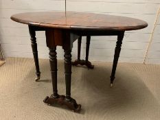 A Victorian Sutherland table, the oval top with drop sides (H74cm W120cm D88cm)