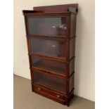 A four tier globe Wernicke mahogany barrister bookcase with glazed doors and decorative mouldings