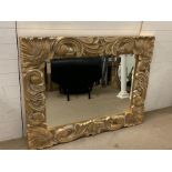 A large carved wall mirror with chunky scroll details (107cm x 139cm)