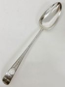 An Irish silver serving spoon, dated 1800 with makers mark JS (32cm in length)