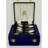 A boxed set of silver plate tea spoons and a boxed set of salt and pepper shakers