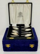 A boxed set of silver plate tea spoons and a boxed set of salt and pepper shakers