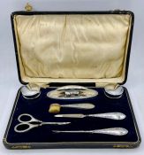 A cased ladies vanity set, silver handled with Greek key design by Henry Matthews and hallmarked for