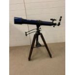 A Meade instruments model 312 telescope blue on stand