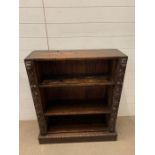 A carved oak open bookcase (H103cm W84cm D27cm)