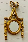 A Round mirror with swag detail