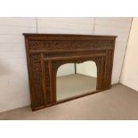 A c19th Indian Carved Teak mirror with shaped glass. The surround carved with flowers, leaves, stems