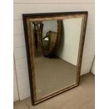 A contemporary wall mirror with a bronze effect frame (74cm x 107cm)