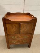 A George III mahogany night table, the two doors enclosing a cupboard and drawers below (H80cm W59cm