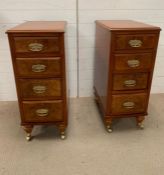 A pair of burr walnut side cabinets on castors