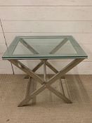 A glass and chrome X frame table (H60cm W59cm D44cm)