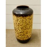 A tall vase with brown, cream fat lava design