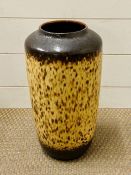 A tall vase with brown, cream fat lava design